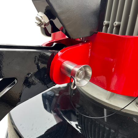 Close-up of a red and black grinder part with a metallic component.